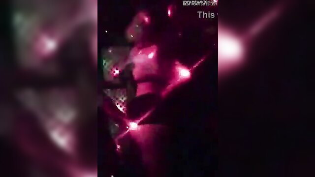 Blurry neon-lit KTV girl in skimpy outfit with glowing lights on body