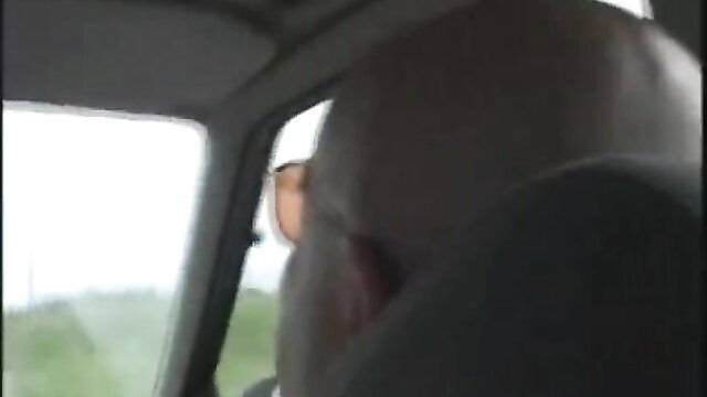 Bald mature man with beard driving car POV view