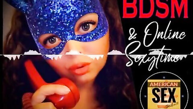 Woman in sparkly cat mask holds phone for cybersex BDSM tease