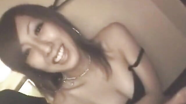 Smiling Asian JAV babe in black lingerie with big tits, closeup smile