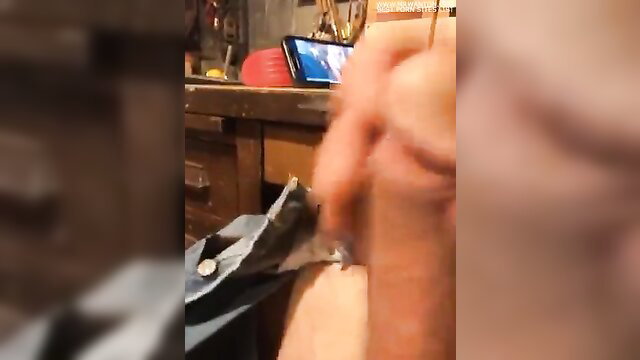 Blurry closeup of man jerking thick cock in workshop solo