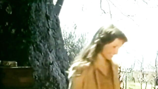 Christin Black as Verena in Wollust, blonde smiling outdoors by tree