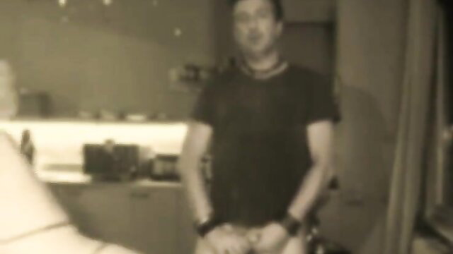 Man in black shirt, hands in pockets, blurry