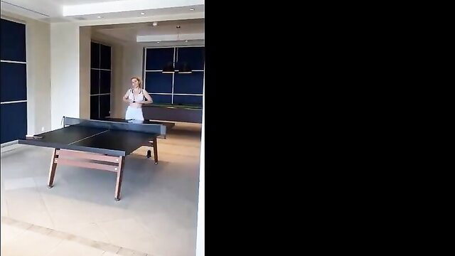 Fit blonde in white sports bra poses by ping pong table