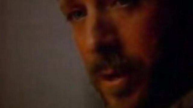 Closeup of handsome bearded man with intense gaze in The Dinner Party 1994 film