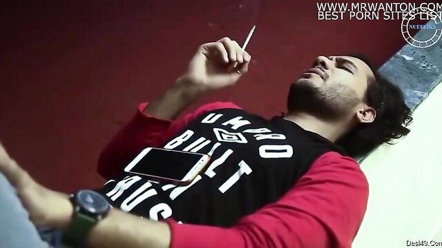 Handsome Latino man reclining, smoking joint, wearing black Build Hustle tee