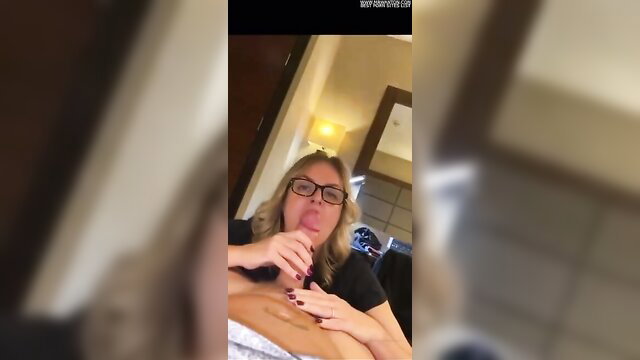 Amateur blonde MILF in glasses sucking cock in hotel room