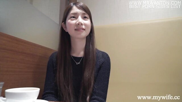 Japanese beauty Chise Mikami smiles in black sweater, long dark hair
