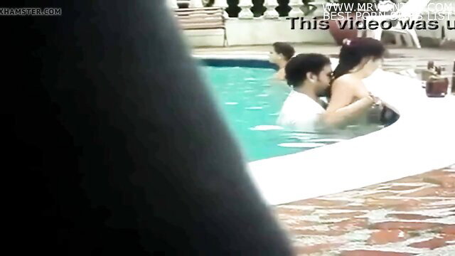 Amateur Asian girl in poolside embrace with man, wet white shirt tease