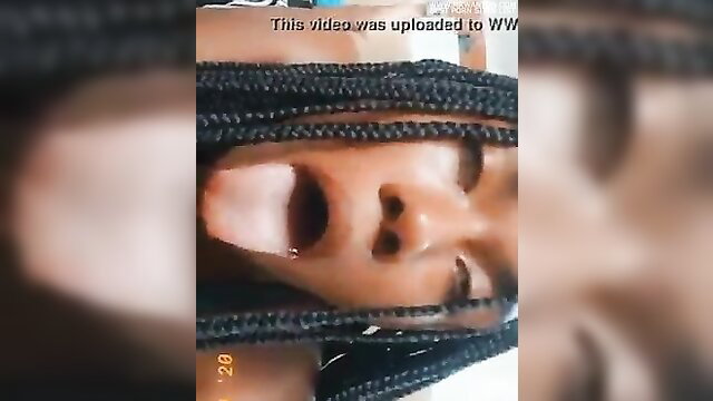 Closeup black woman with braids sticks out long wet tongue for fetish