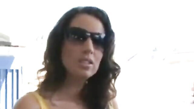 Tessa West in yellow tank top and shades, sultry look