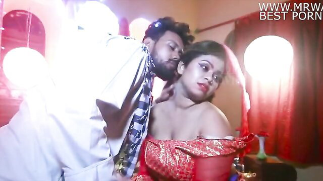 Indian bride in red saree passionately kissed by groom in intimate scene