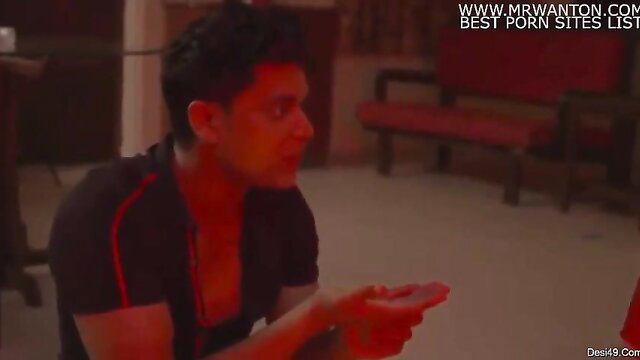 Indian man in tight tank top holding phone in steamy amateur scene