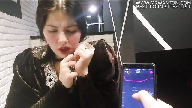 Brunette in velvet dress teases with Lovense Lush vibrator app