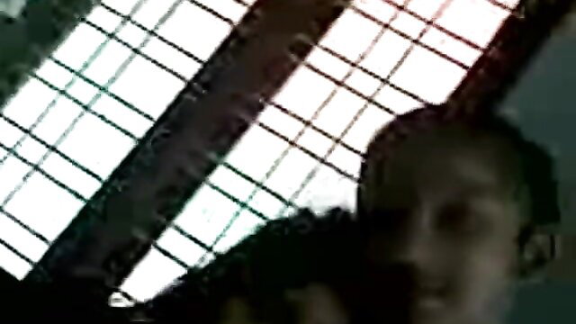 Blurry Indian aunty closeup in dim room with window grilles