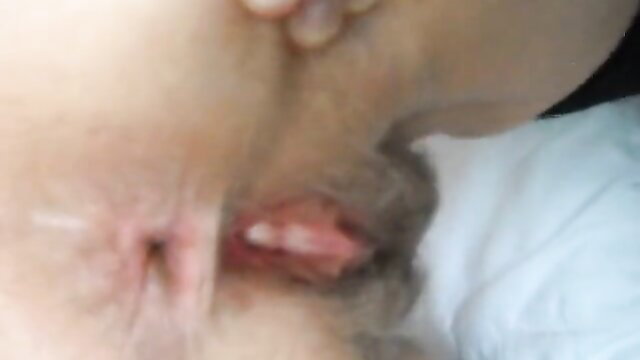 Closeup rear view of woman's gaping anus and pink vagina post-sex