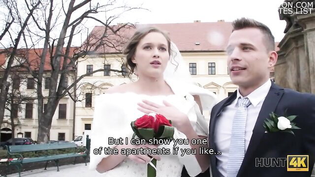 Hot bride in white dress with groom showing apartment on wedding day
