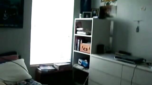 Hot college girl undresses in bedroom, teasing striptease