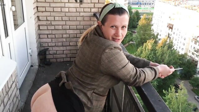 Curvy brunette in tweed jacket moons huge ass on balcony, teasing anal