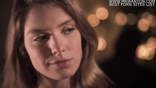 Closeup of seductive brunette lesbian babe with sultry gaze, soft lighting