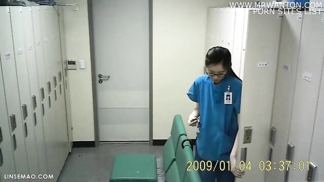 Asian nurse in scrubs bending over in locker room, upskirt view