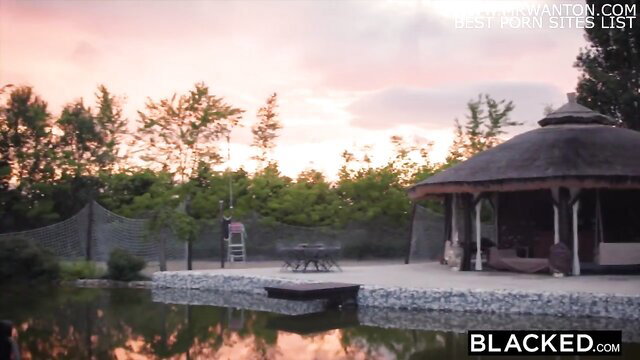 Eveline Dellai by scenic lakeside gazebo at sunset - Blacked