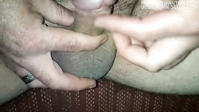 Man's hand stroking leaking cock with precum in hot masturbation closeup