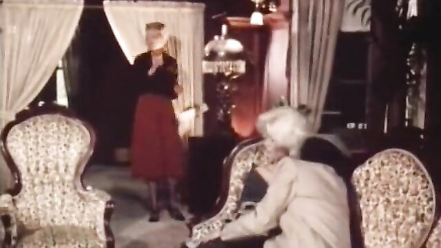 Seka in elegant red skirt dress chats with older woman in vintage 1980 adult scene