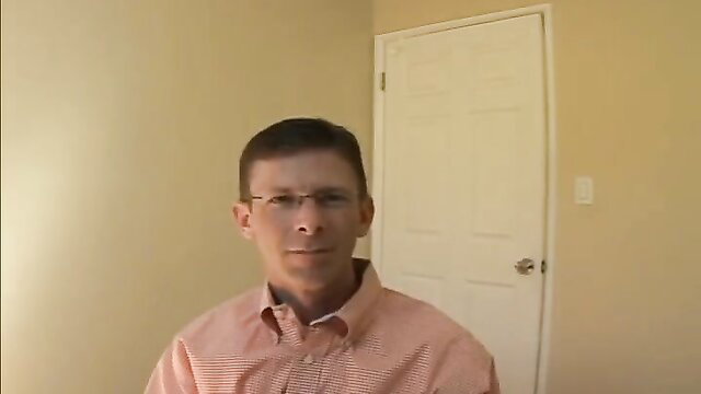 Perverted coach in orange shirt smirks at camera in indoor setting