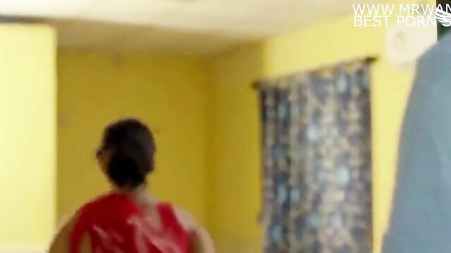 Indian wife in red dress walks toward man in cheating friend's wife scene