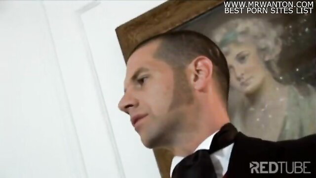 Handsome suited man in tuxedo gazes at elegant woman portrait in luxurious setting