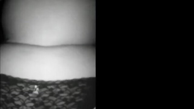 Blurry closeup of woman's lace panties and pale thighs in erotic night pose