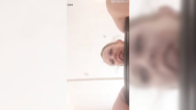 Blonde woman's pained face closeup during intense spanking session