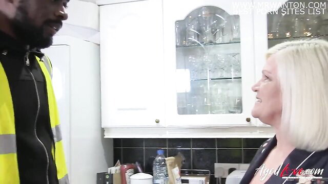 British mature blonde MILF with black hi-vis worker in kitchen
