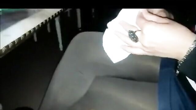 Woman's hand with black ring holding tissue in car, amateur public tease