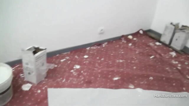 Skinny mature in messy room, paint splatter on red floor