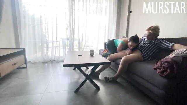 Blonde Toma Mur cuddles sexy Asian girl on couch in hotel room