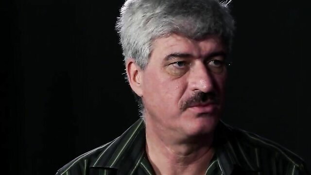 Mature man with gray hair and mustache in intense interview, Wheel of Pain 09