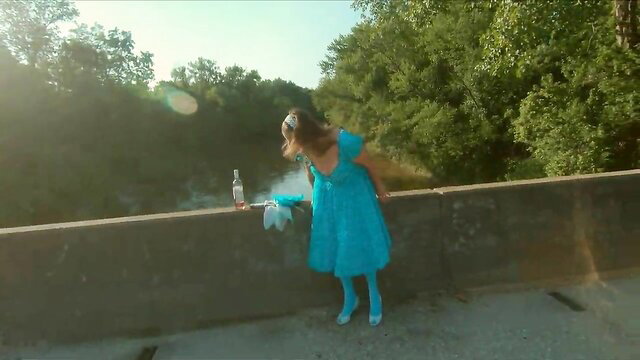 Ginger B as hot Alice in blue dress on bridge with bottle
