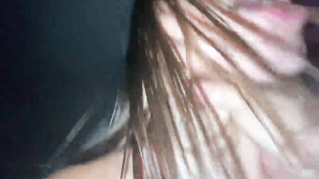 Closeup of moaning girl's face with long brown hair in intense adult video