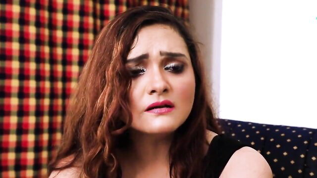 Indian beauty with sad eyes in black dress, sultry web series scene