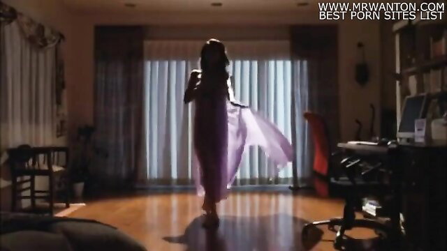 Silhouette of sexy Asian woman in sheer purple dress, teasing indoor walk