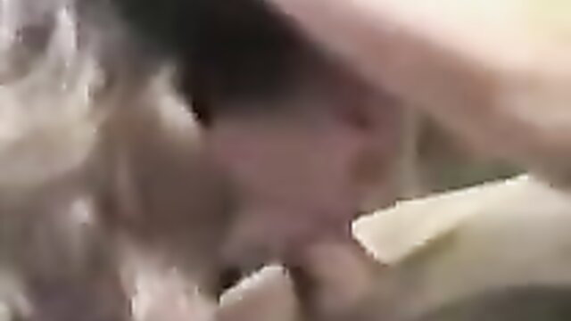 Mature woman with blonde hair giving intense closeup blowjob