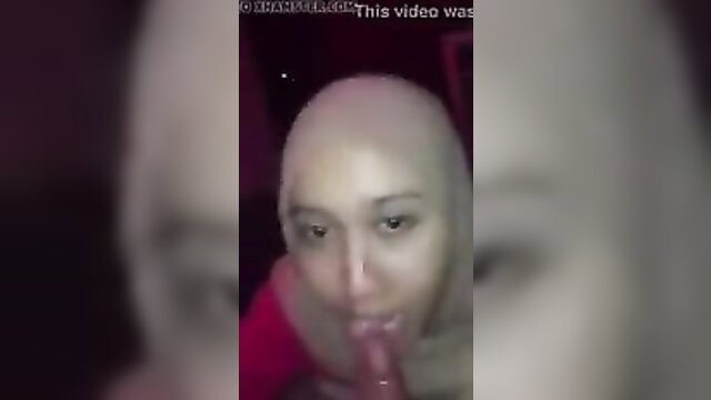 Asian woman in balaclava deepthroating dildo closeup