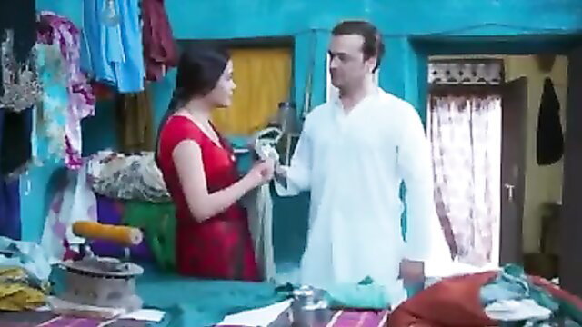Indian couple in red dress and white kurta in steamy tailoring scene