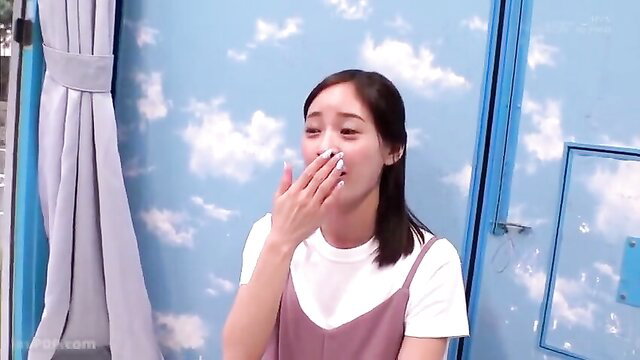 Shocked Asian MILF covering mouth in surprise, cute face closeup