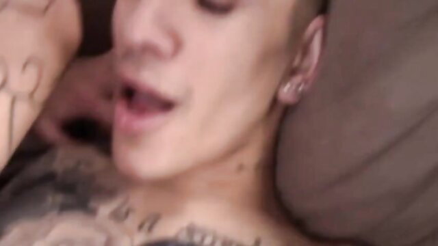 Tattooed twink with shaved head in bareback gay action, mouth open ecstasy