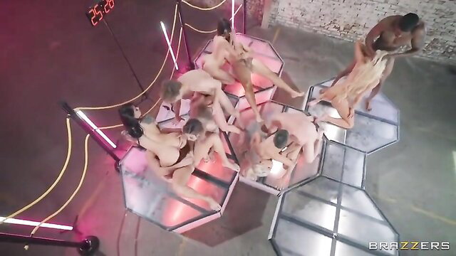 Hot MILFs in wild group orgy on glowing platforms, intense gangbang action