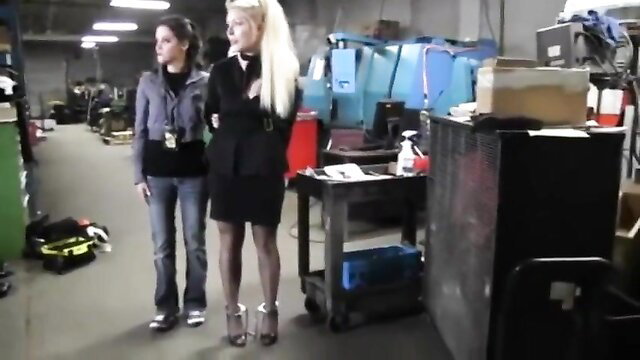 Blonde in mini skirt and heels arrested by brunette cop in BDSM fetish
