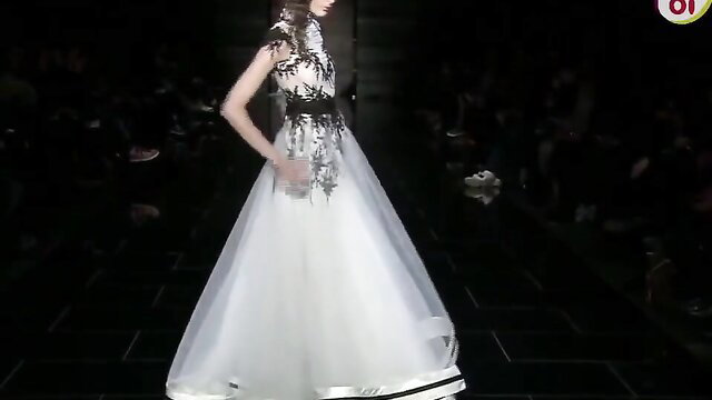 Asian model in lace gown on runway, BDSM fashion tease